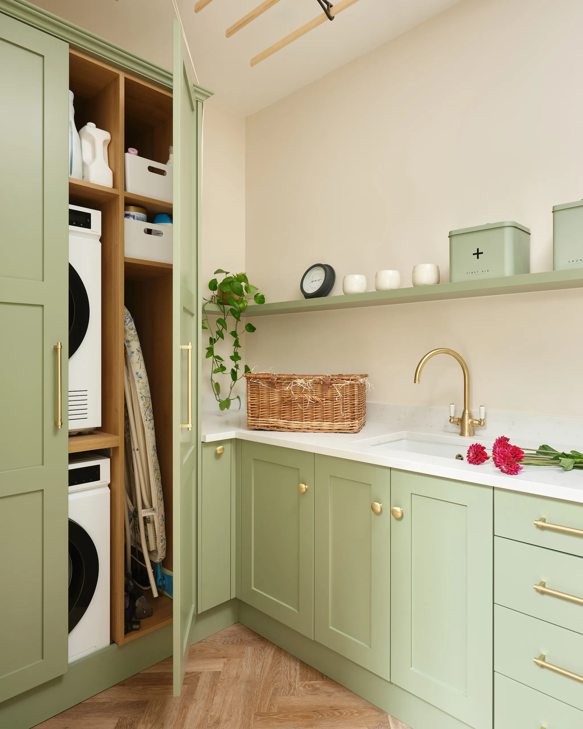 Pale green cabinetry with hidden appliance storage