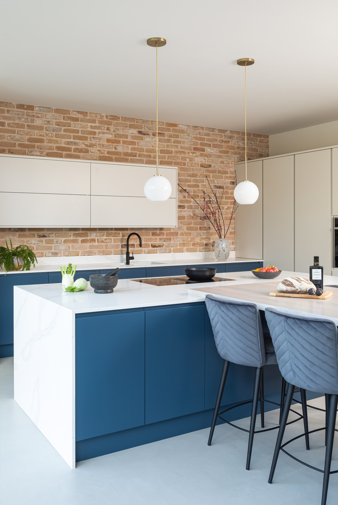 blue and white kitchen with two ball shaped lamps