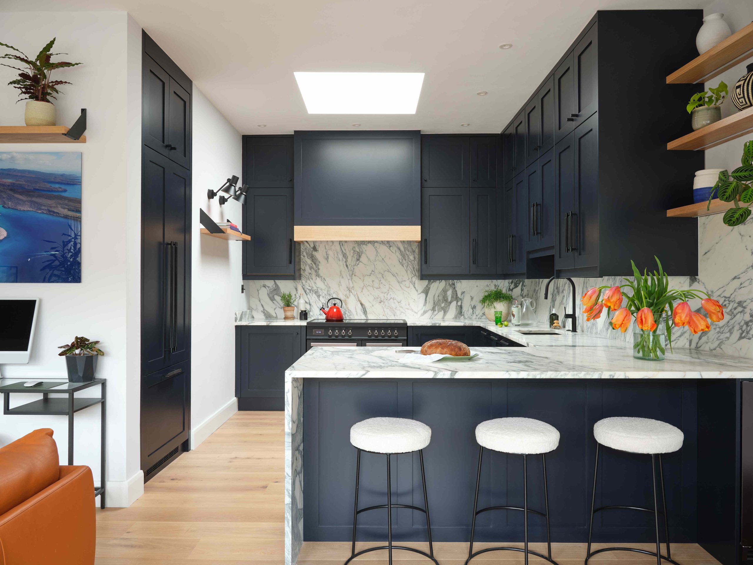 blue kitchen with white stools